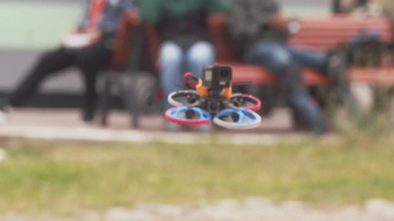 FPV drone mounted with a POV camera moving towards the camera head-on moving away at last moment avoiding the camera