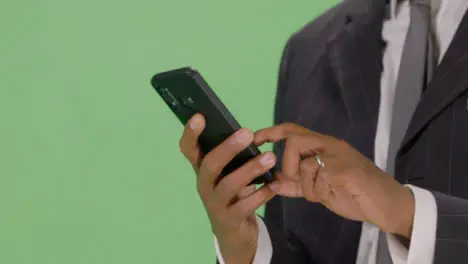 CU Businessman texting on phone with green screen