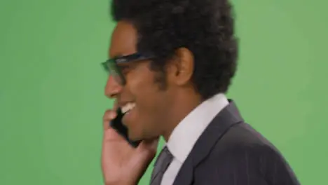 CU Happy Businessman walking and talking on phone with green screen