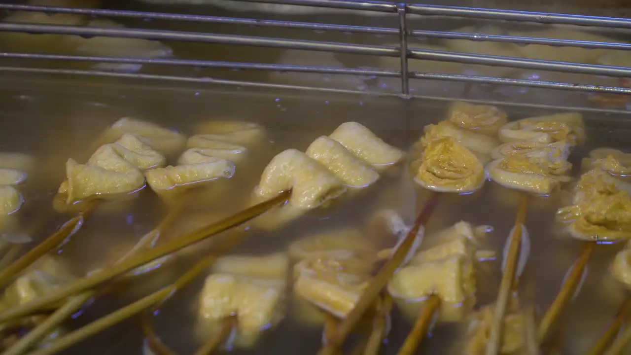 White plain not spicy Korean oden on wooden skewers boiling in salty soup