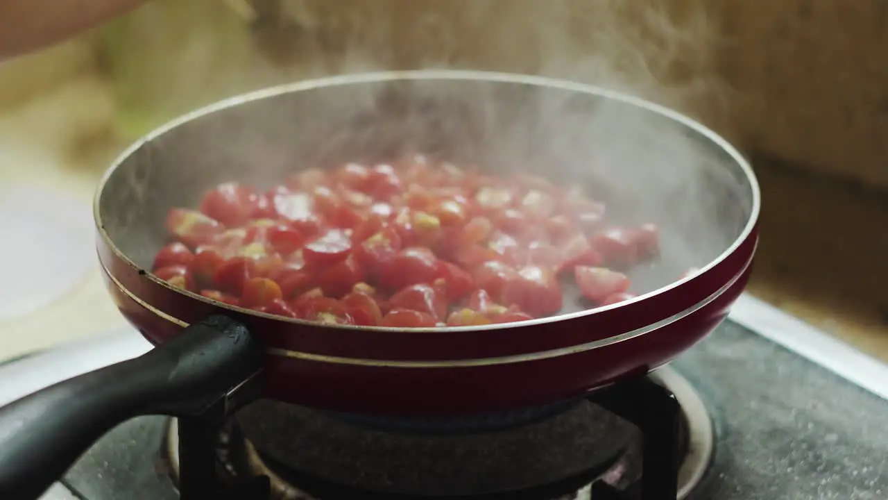 Spray olive oil on pan to fry tomatoes