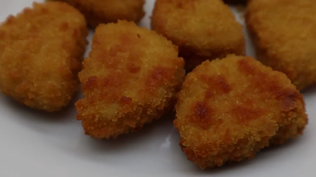 Baked crispy chicken nuggets on white plate