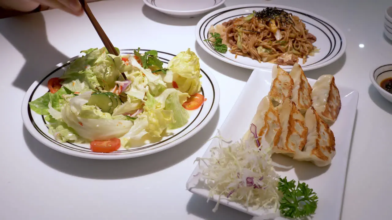 A helthy meal of vegetable salad chow mien and dumplings served in a restaurant in Pattaya in Chonburi province in Thailand