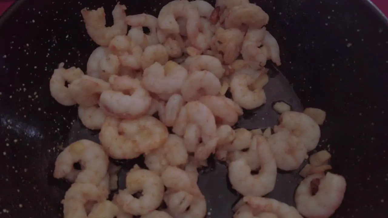 Spanish Garlic Shrimp in Black Frying Pan Wok Close Up Pedestal Down