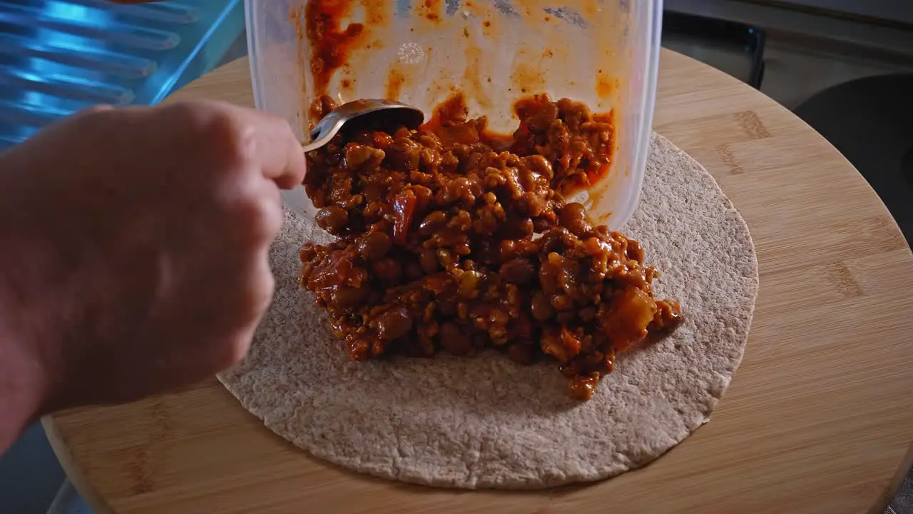 Making Tortilla With Spicy Turkey And Beans Filling