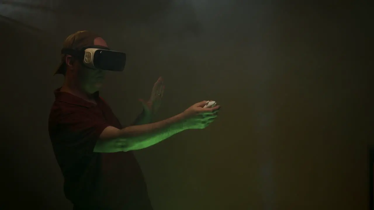 Man plays game while wearing VR headset Virtual Reality headset