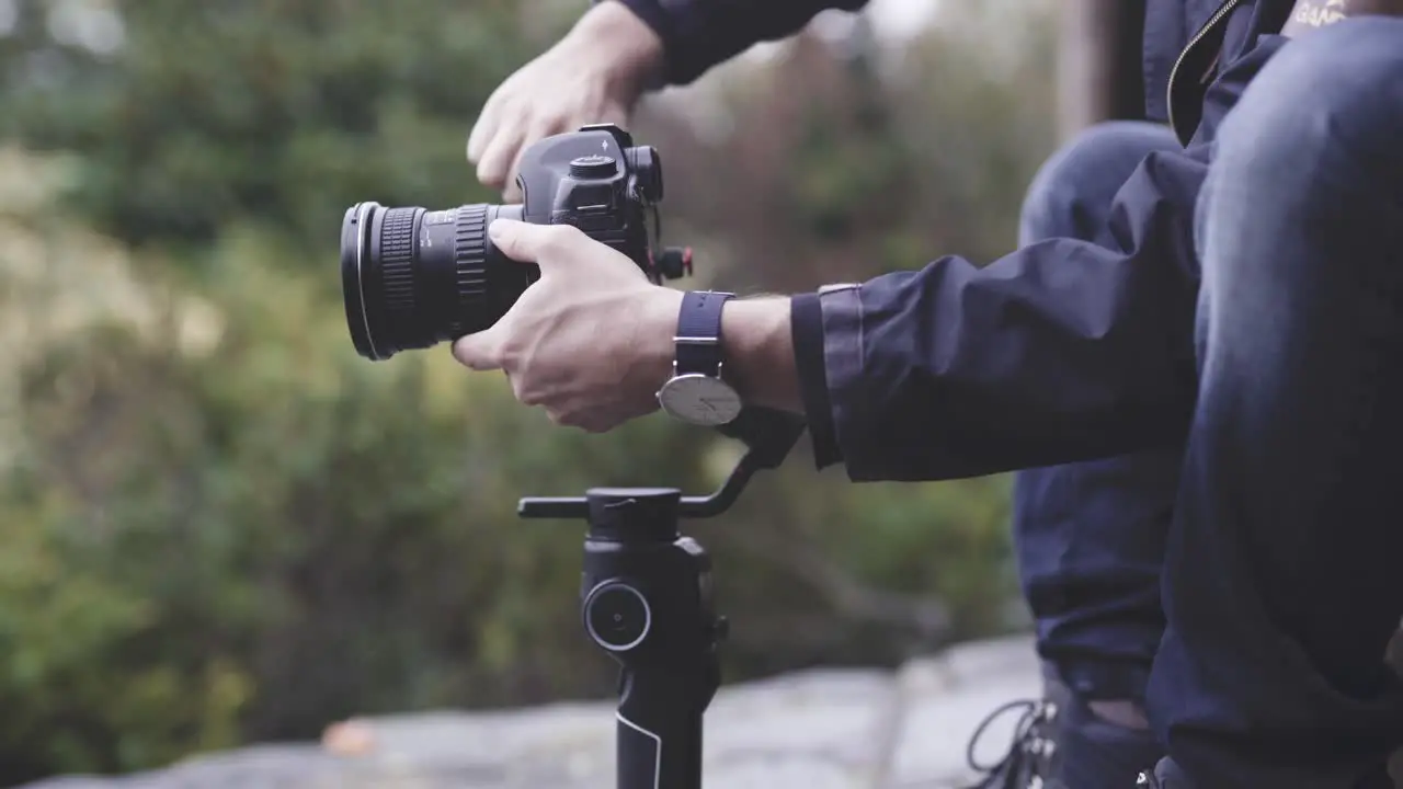 Cameraman stabilizing camera on gimbal close up shot