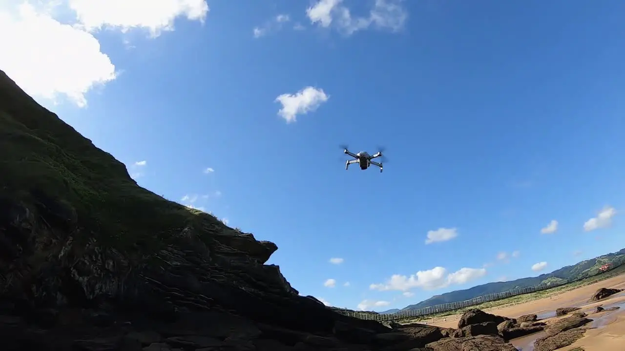 Small drone taking off on a beach