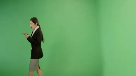 Annoyed Woman Texting While Walking on Green Screen