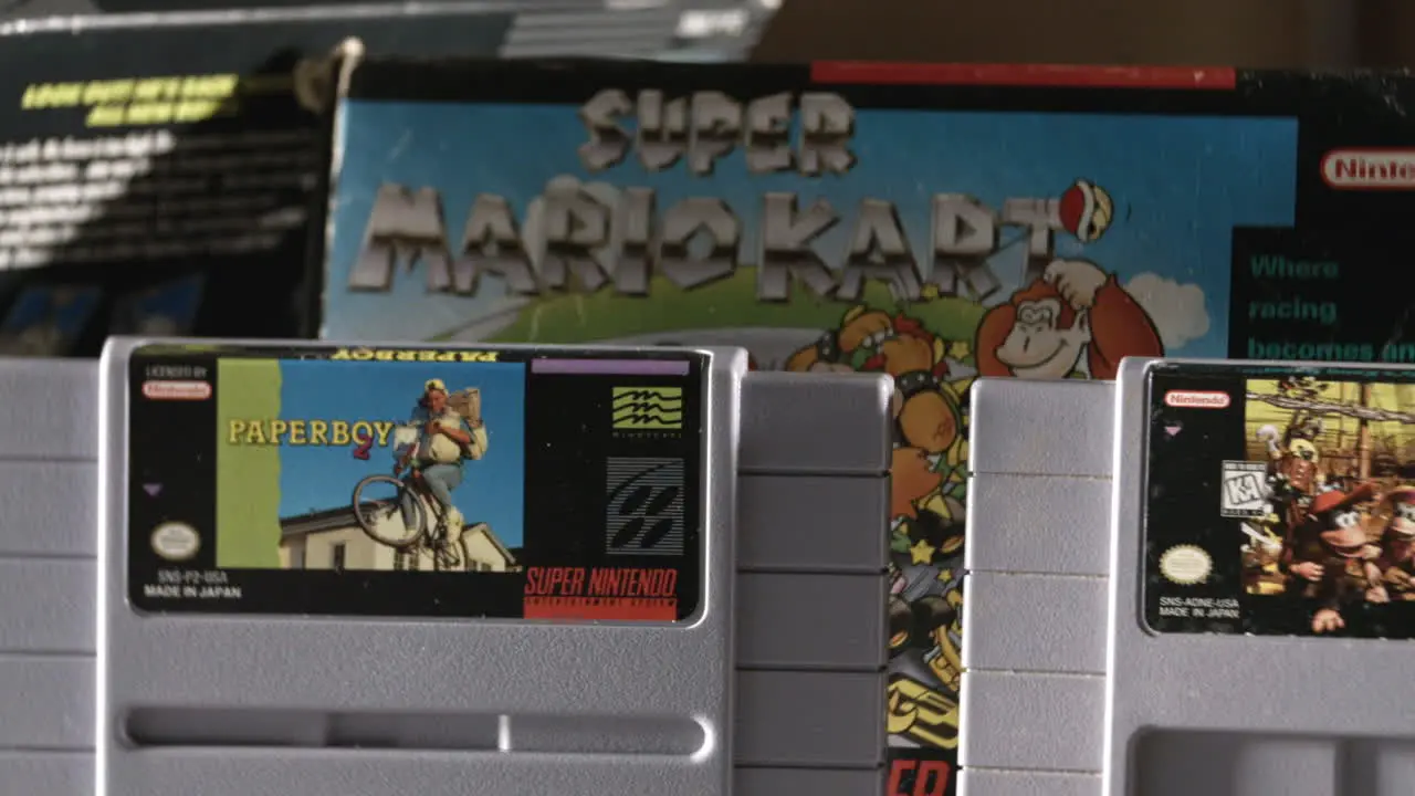 Vintage Super Nintendo Cartridges with Box in Background SLIDE LEFT