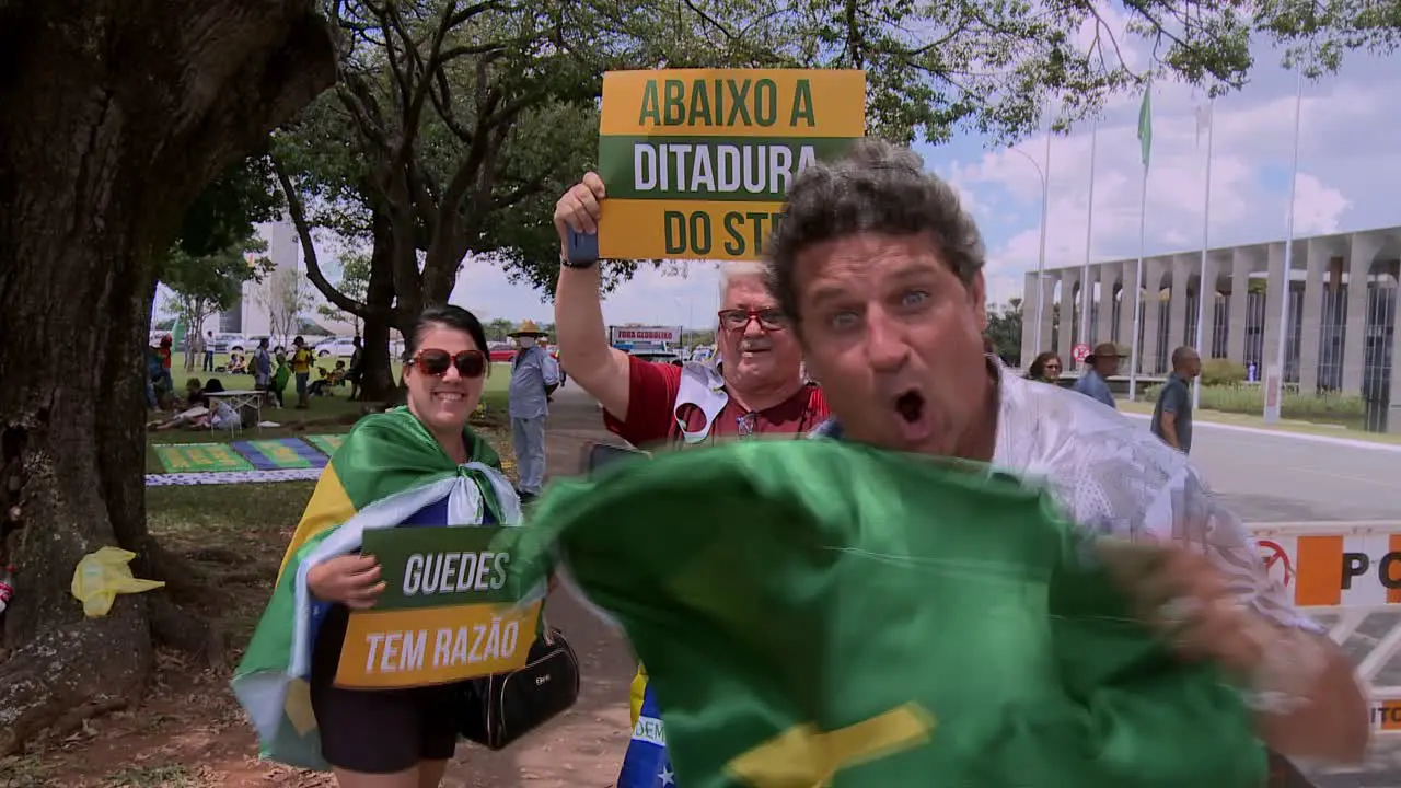 Right wing supporters of President Bolsonaro wave flags at a demonstration