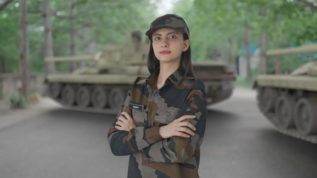 Portrait of Indian woman army officer standing crossed hands