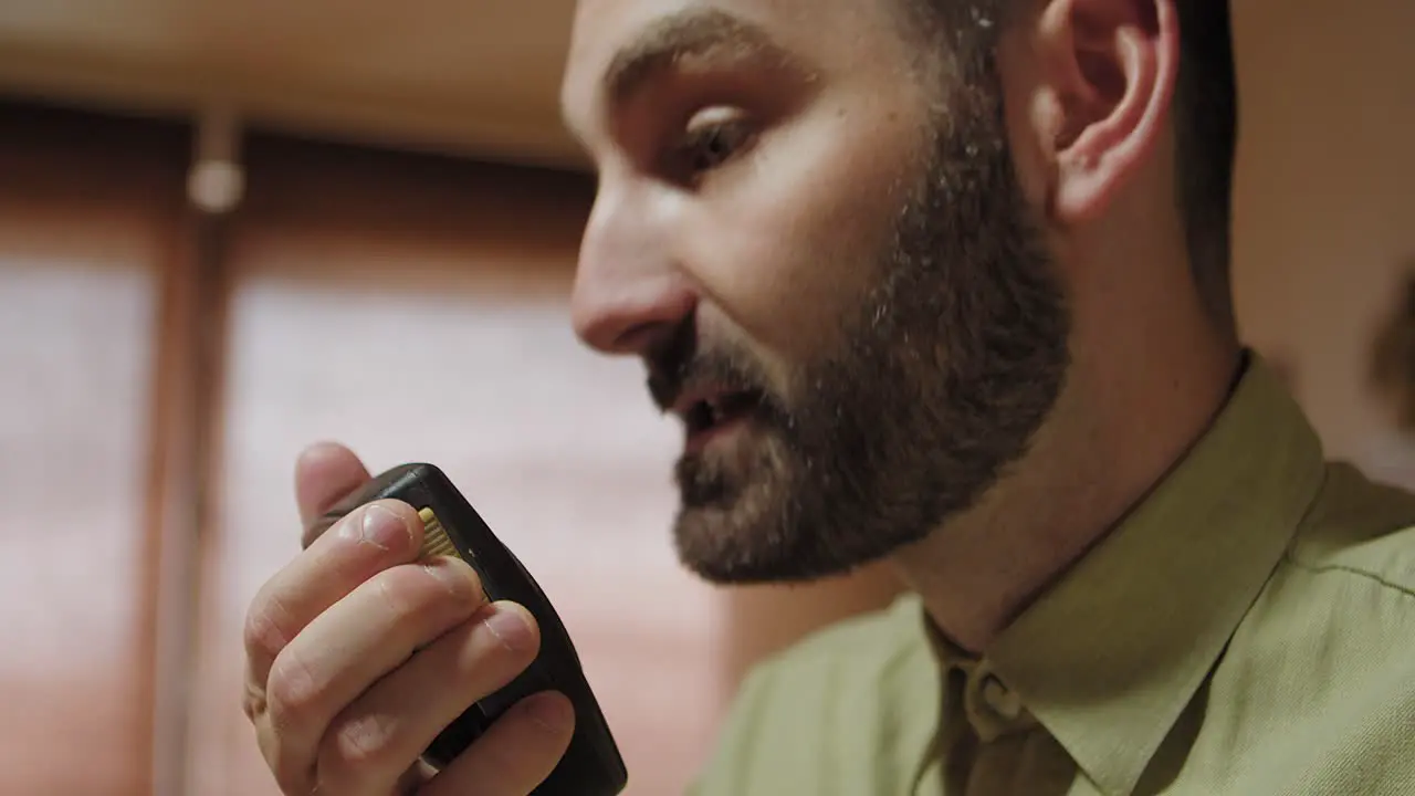 Sergeant using walkie talkie making commands gun on table low angle shot