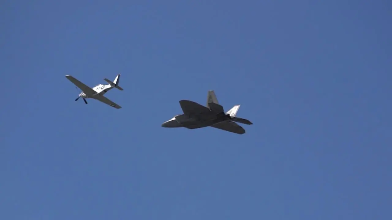 A legacy flight of a P51 Mustang and the United States most advanced fighter aircraft the F-22 Raptor in a fly by during Wings over Houston Airshow 2021