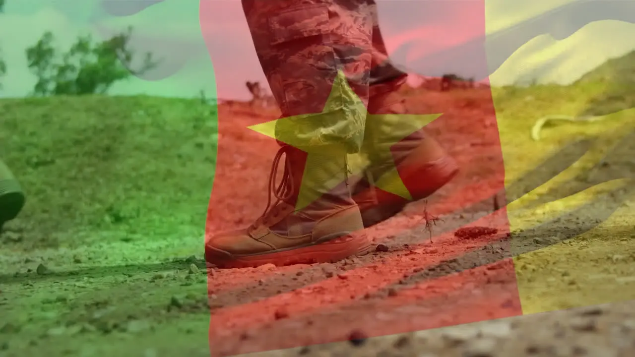 Animation of flag of cameroon waving over low section of marching soldiers