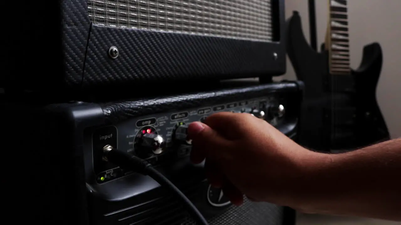 Close- up of old analog amplifier guitar in background