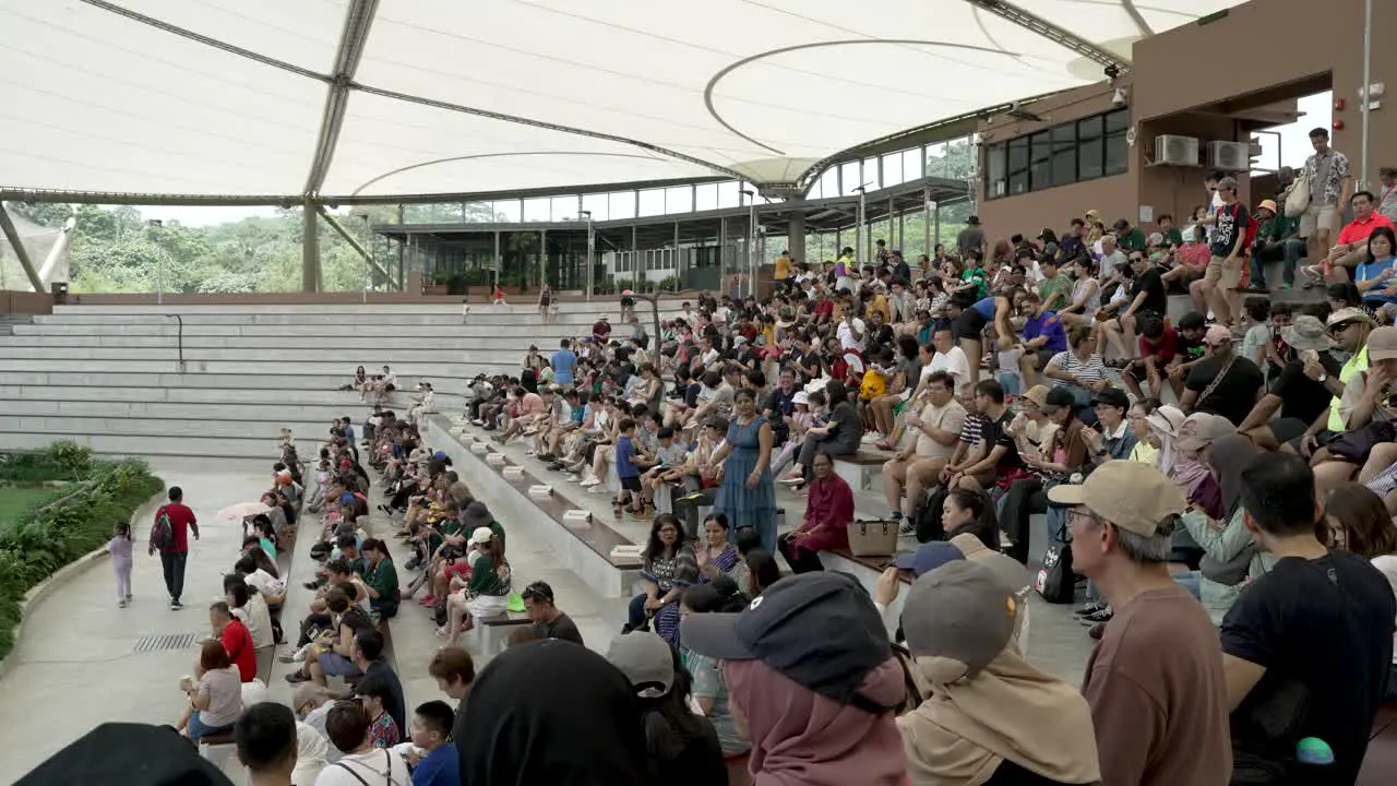 Visitors Finding Space To Sit In The Sky Amphitheatre Prior To Presentation At Bird Paradise Zoo In Singapore