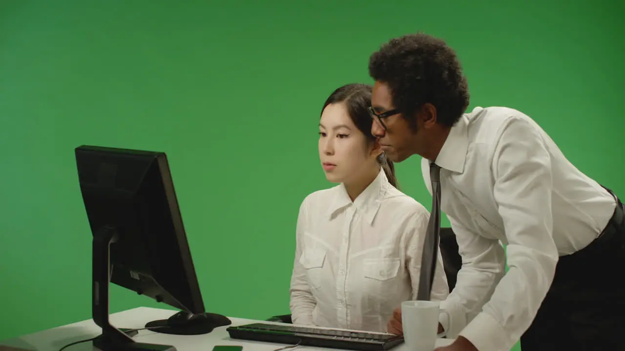 Businessman Checking on Woman at Computer