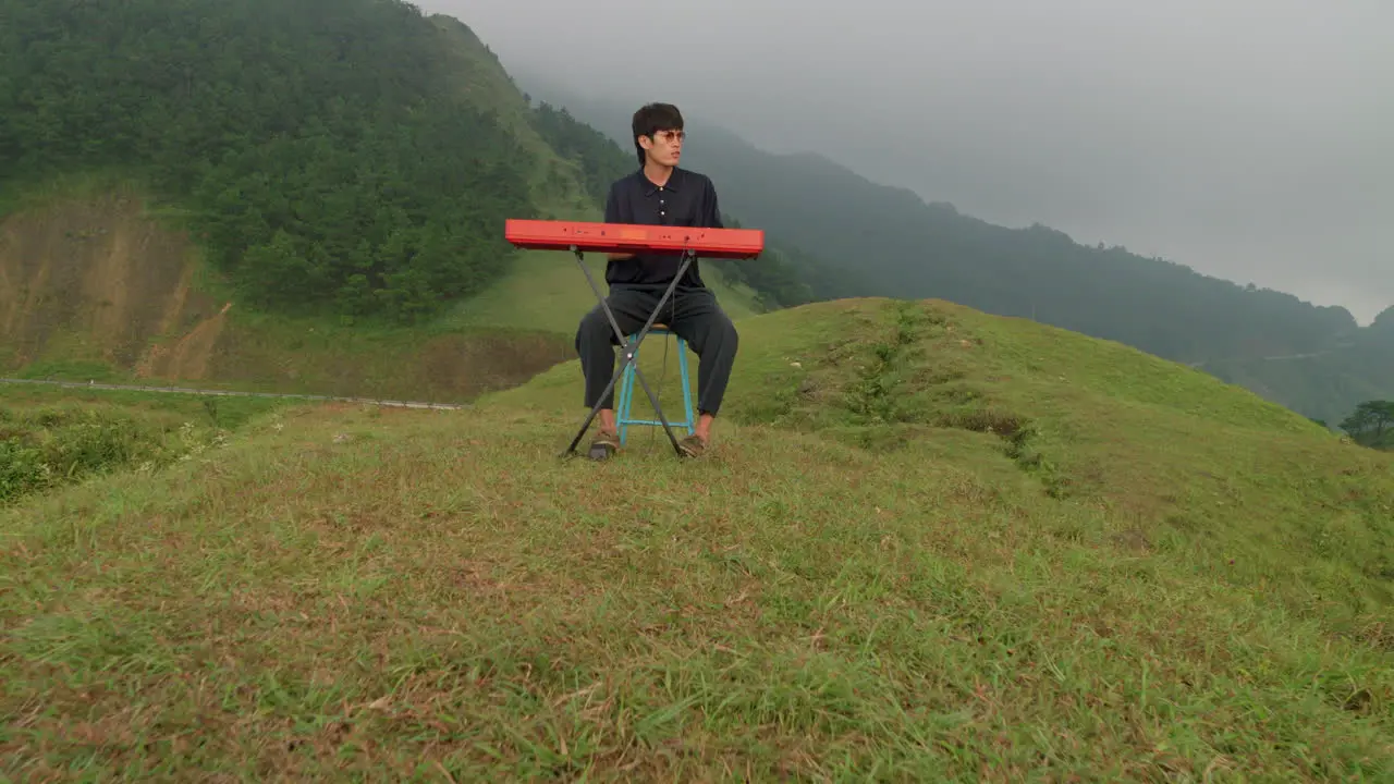 Musical artist playing his keyboard player outdoors