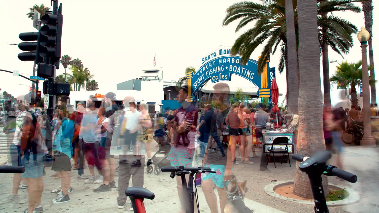 A 4K time lapse of the crowds in front of the Santa Monica Pier Sign in Santa Monica California USA on 09-01-2019