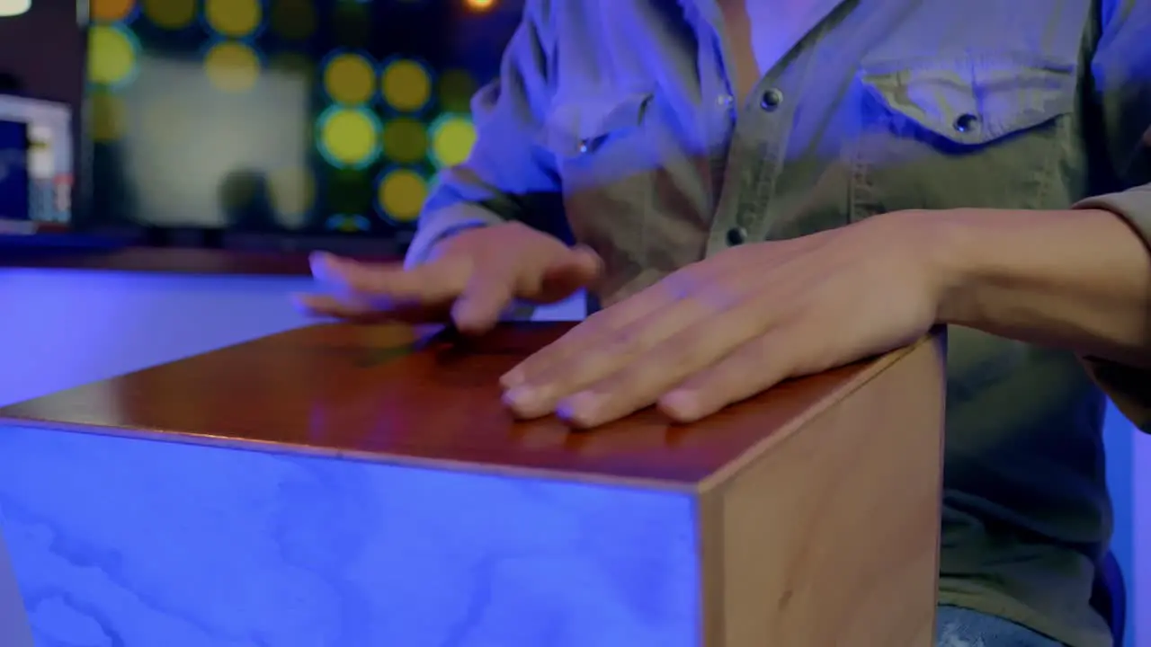 Musician Playing Percussion Wooden Bongo Colorful Lights In Background