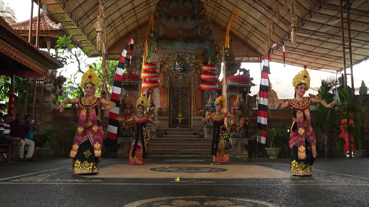 women in traditional Indonesian clothing for ceremonial purposes performing a typical Balinese dance from Hindu folklore in costumes and jewelry