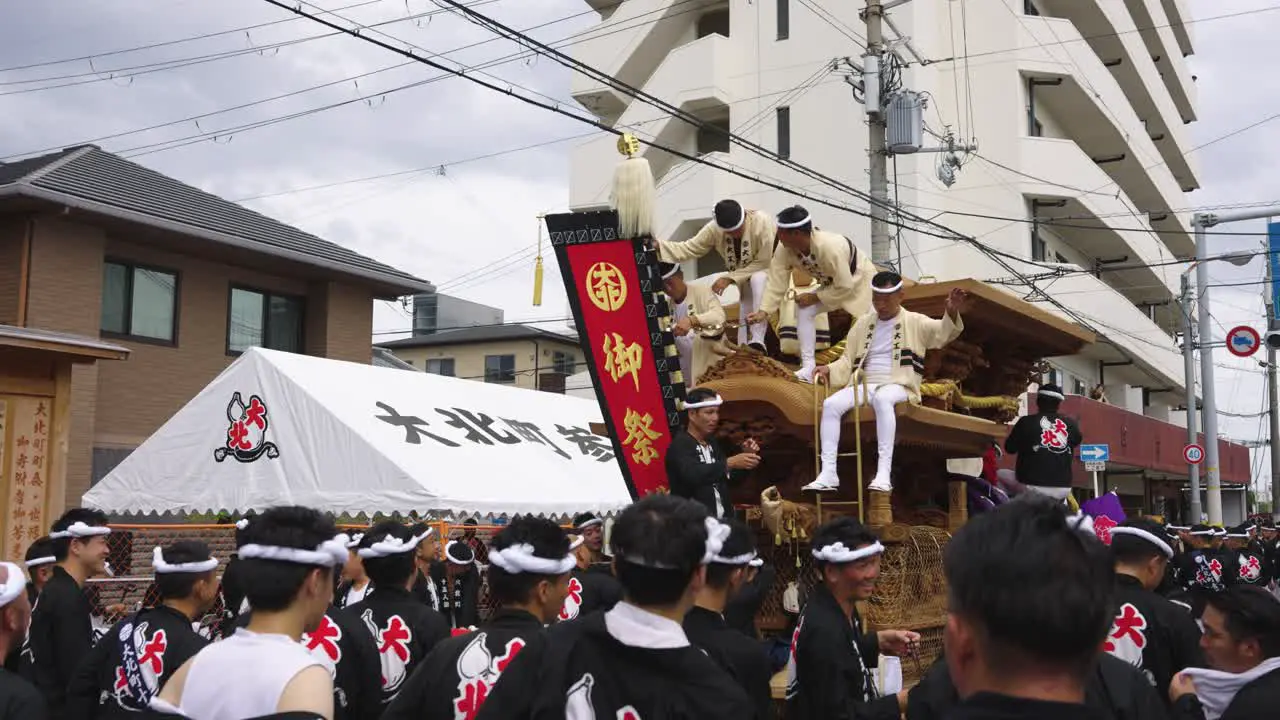 Japanese Men Sit on Danjiri Float waiting for Kishiwada Festival to Begin