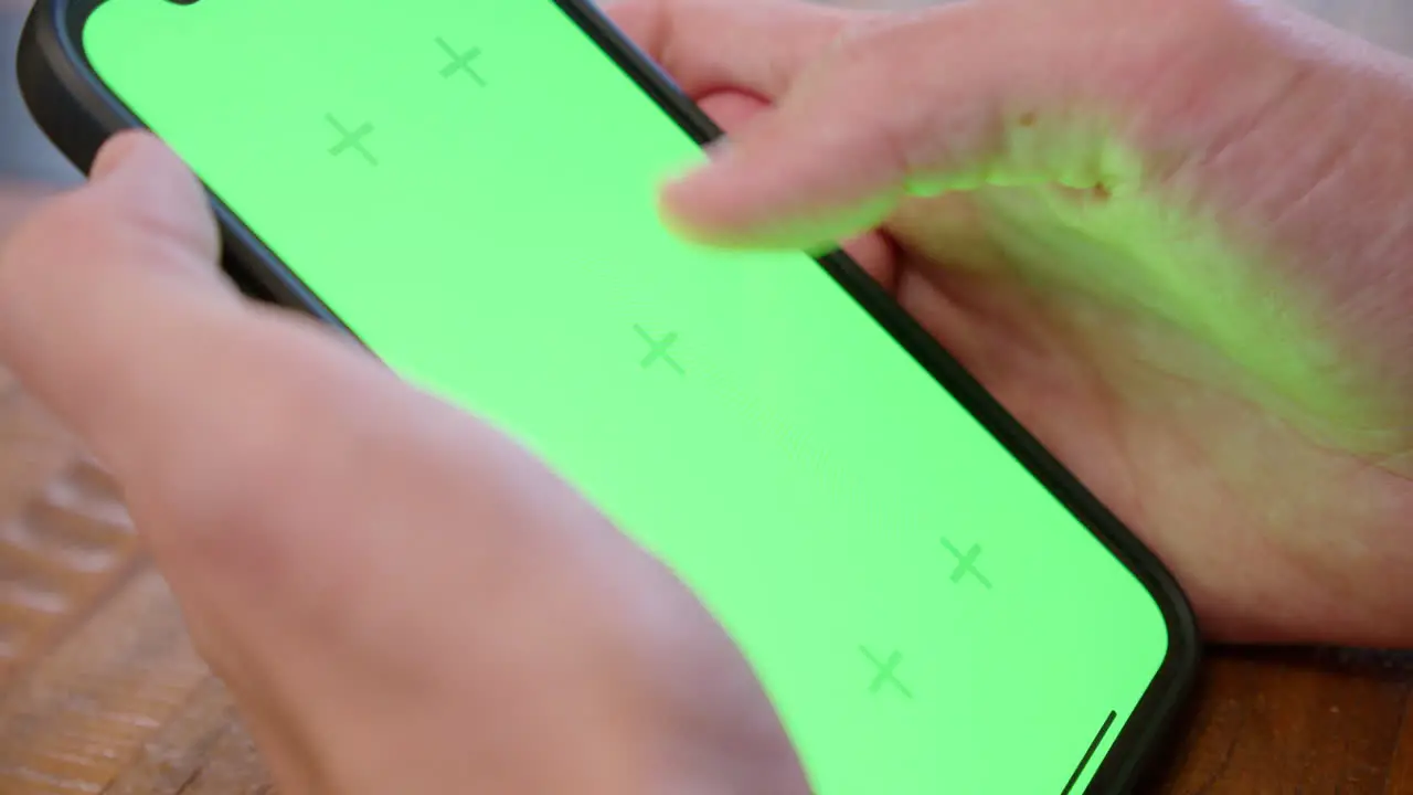 Cinematic close-up of an iPhone screen with the hand and fingers visible in the frame