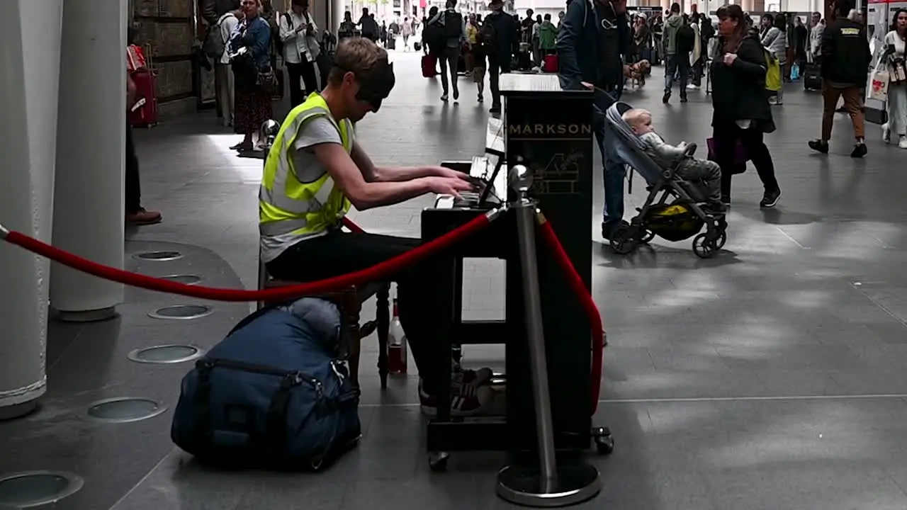 Playing the Piano within Kings Cross Station London United Kingdom