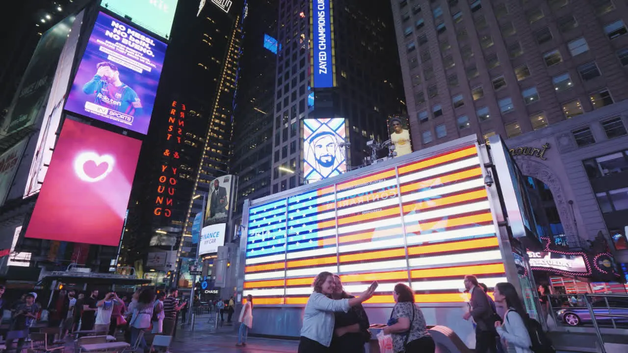 People Walk And Take Pictures On The Famous Times Square In New York