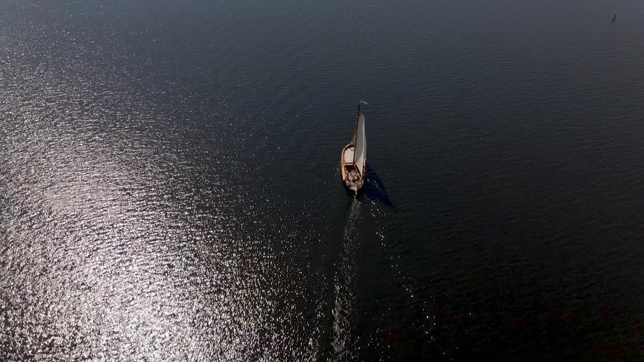 High Aerial of traditional sailboat sailing over sea