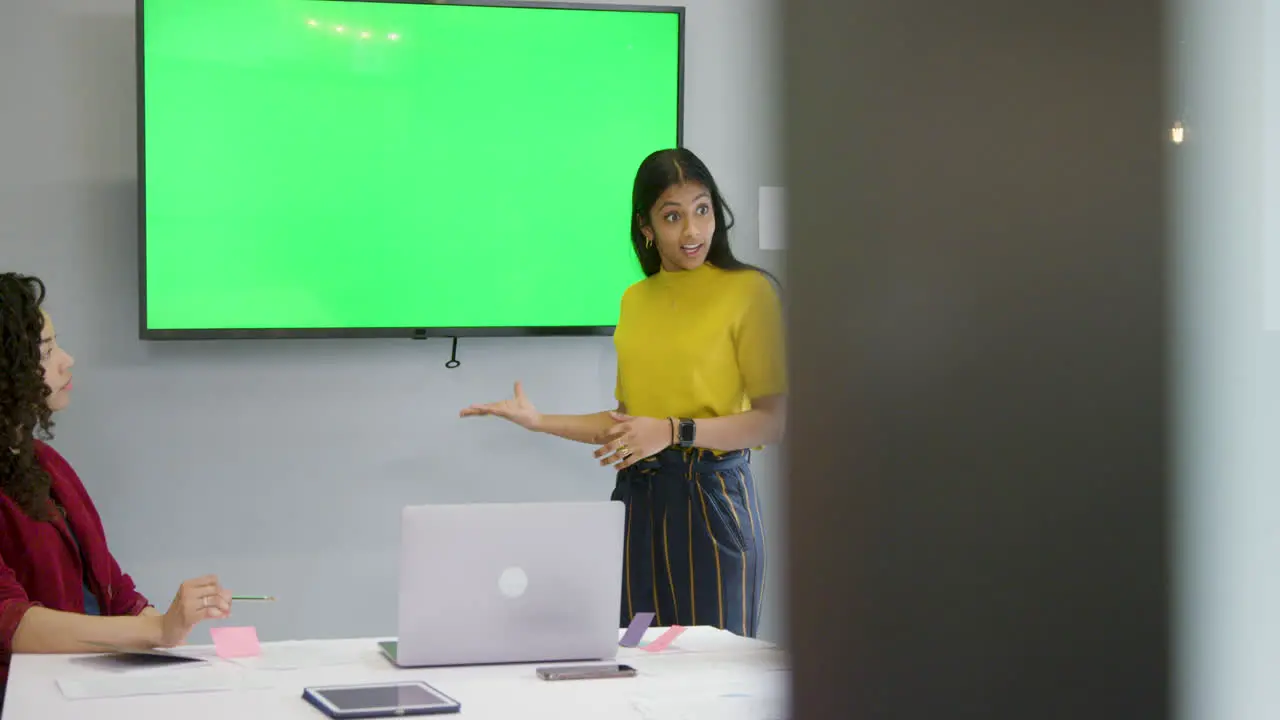 Woman Leading Meeting With Colleagues Using Green Screen