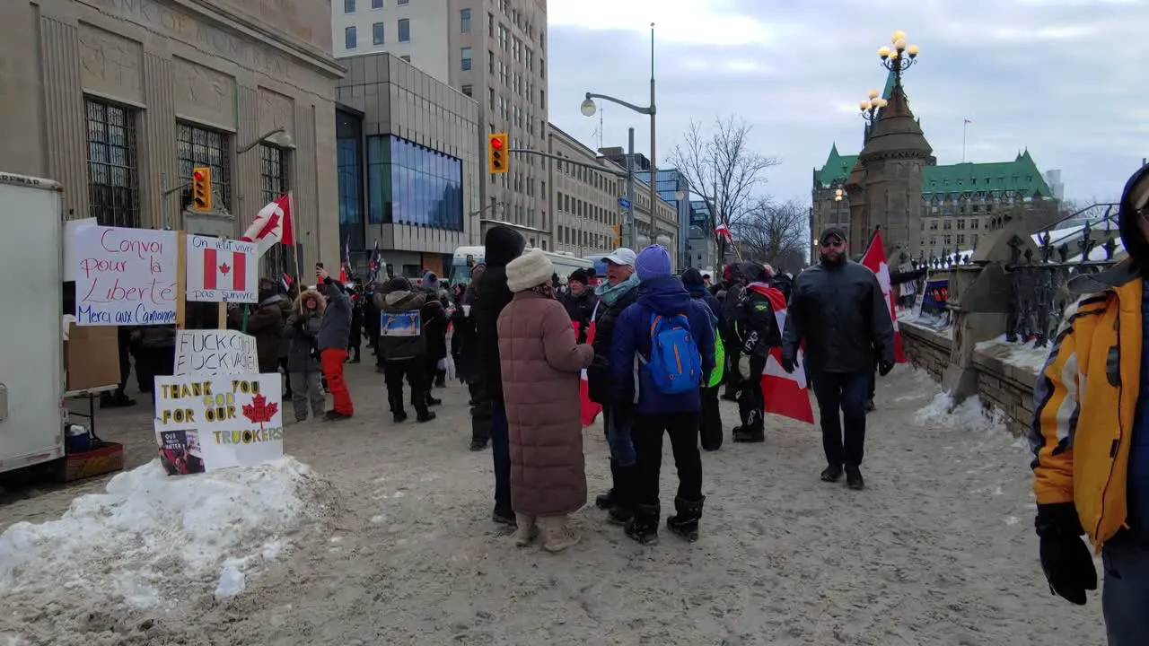 People protesting on Ottawa Street Freedom Convoy rally Canadian Flags Walking motion