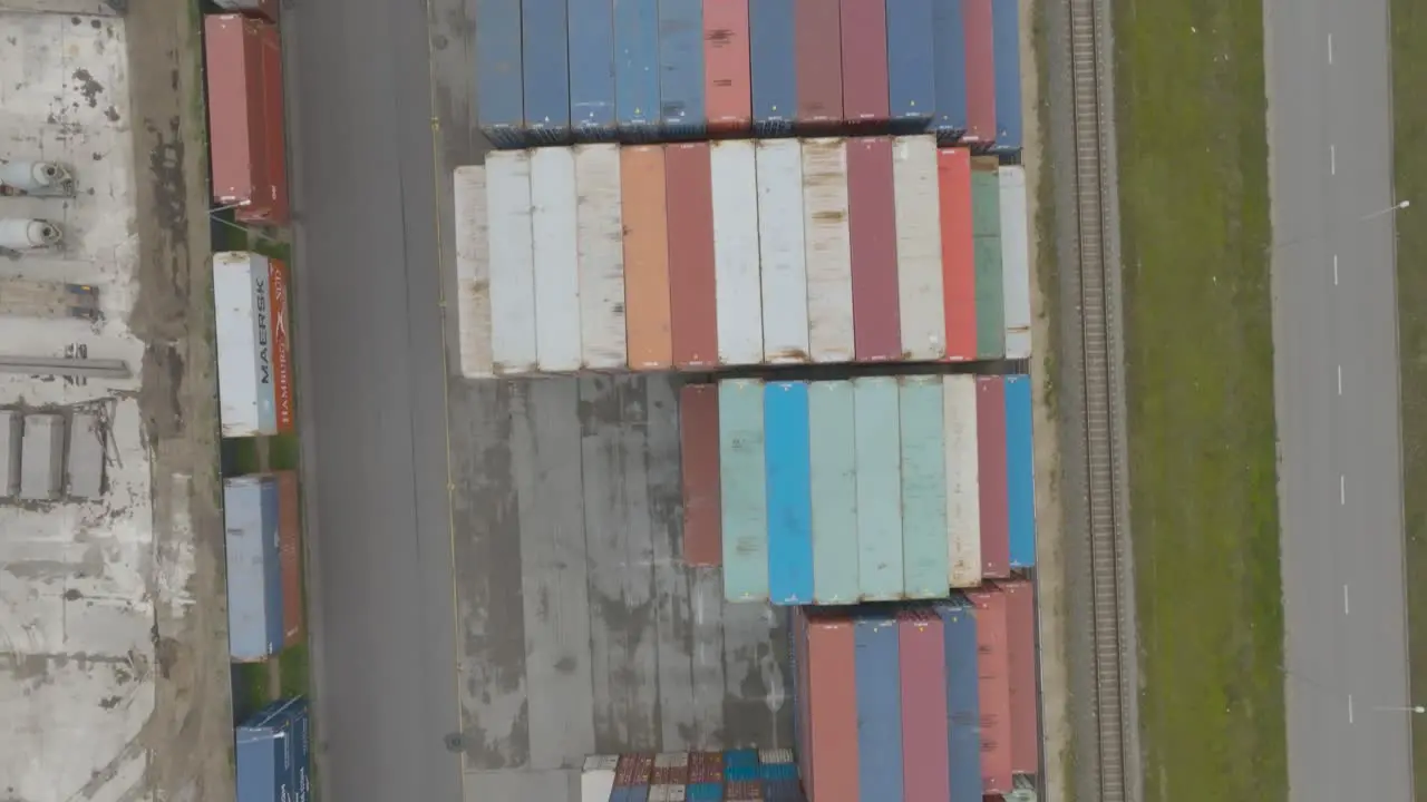 Top view of many empty metal sea containers lined up in a port terminal