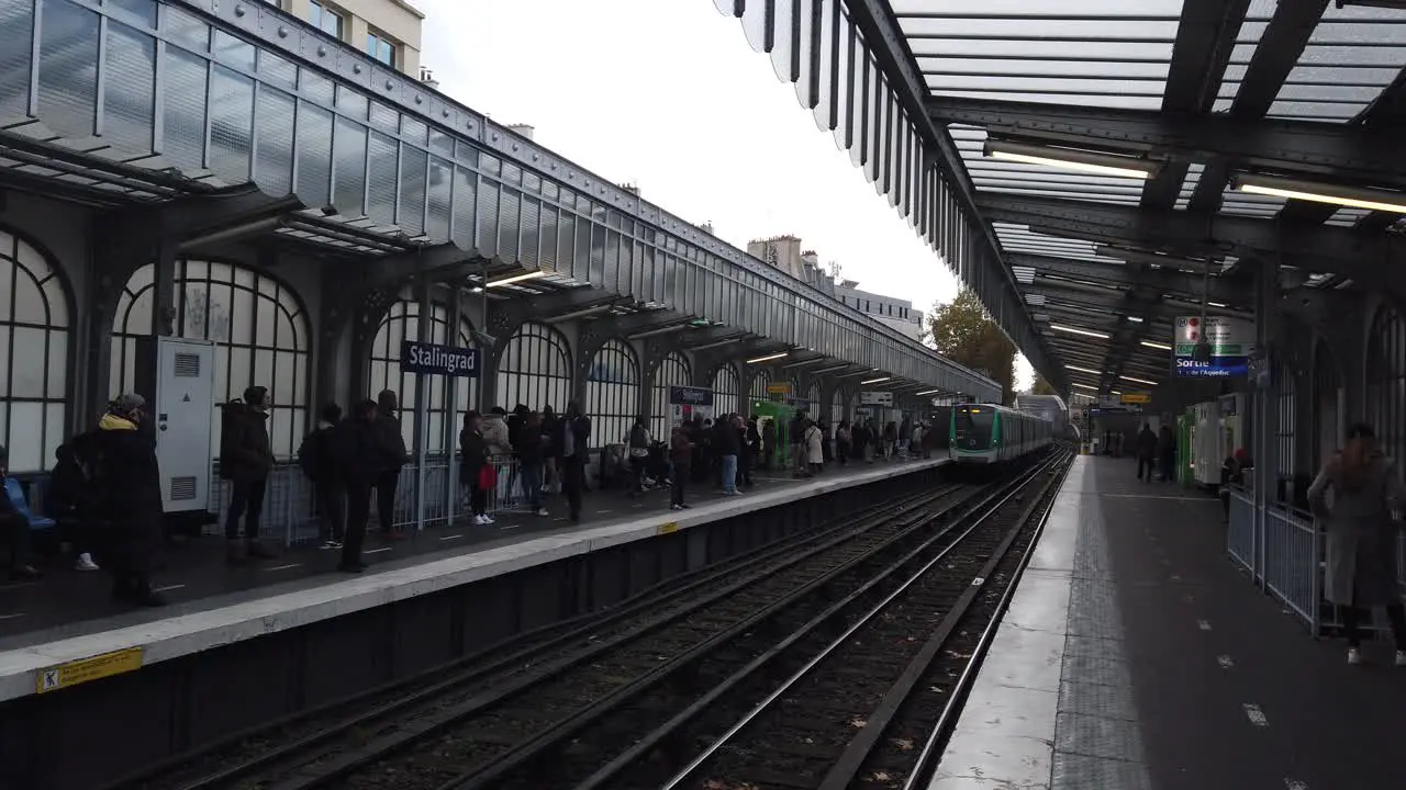 People Wait for Train Arriving to Paris Metro Outdoors Stalingard Rail Station