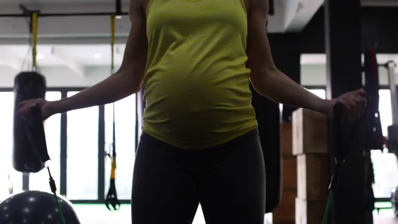 Pregnant female fitness model doing body weight exercise in a gym to keep fit during her third trimester of pregnancy-4