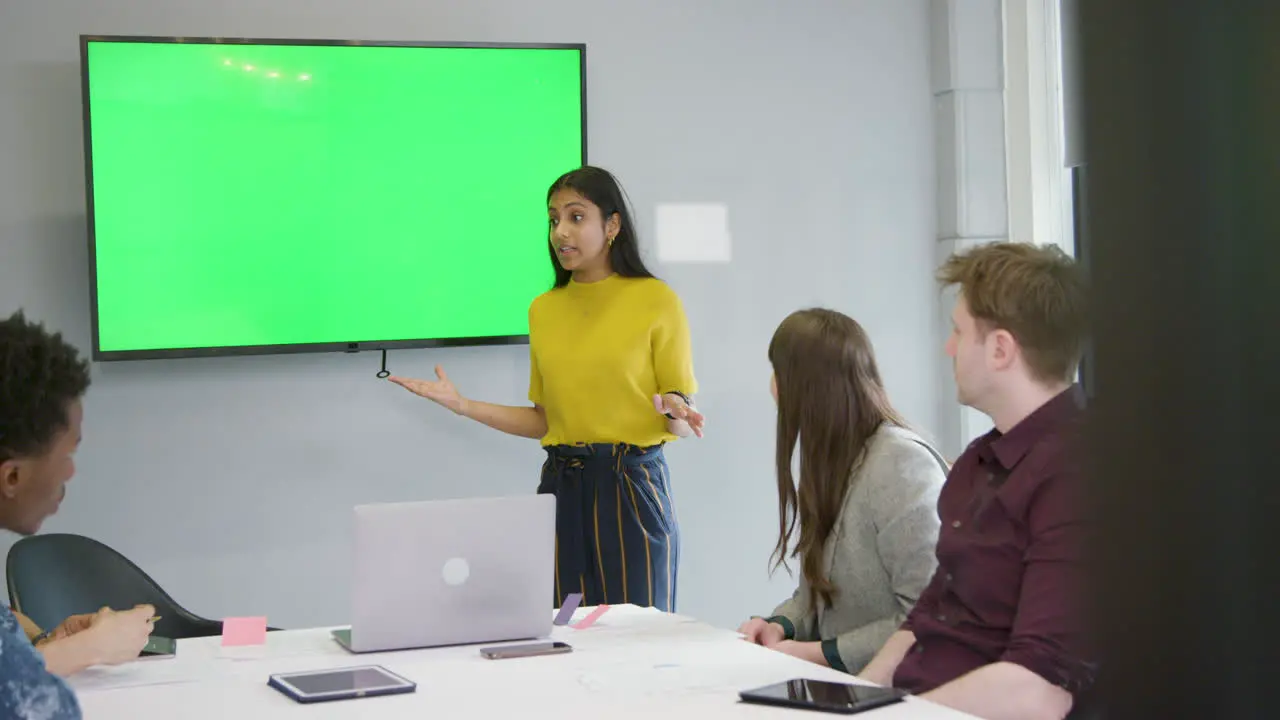 Woman Giving Presentation Business Colleagues Using Green Screen 