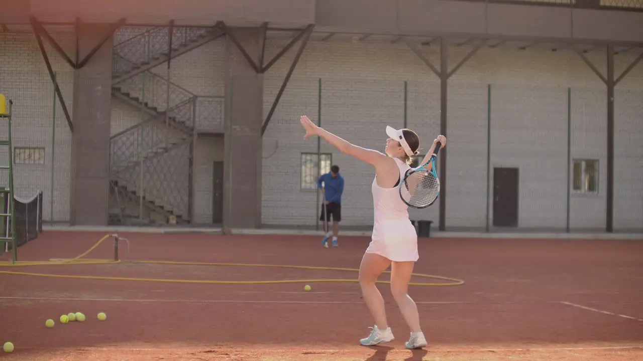 Tennis game on sunny day at tennis court young sportive woman playing