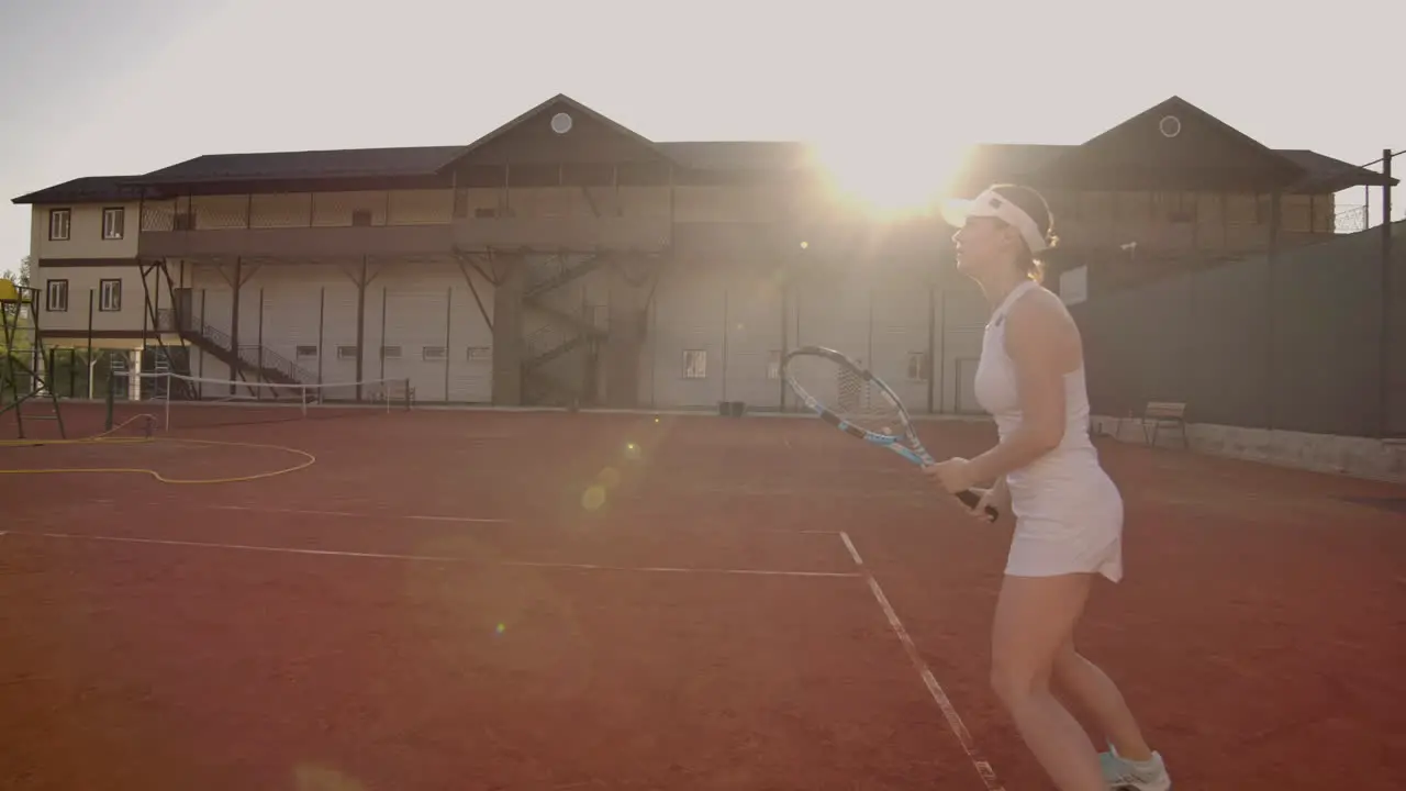 Tennis game on sunny day at tennis court young sportive woman playing professional tennis Tennis game on sunny day