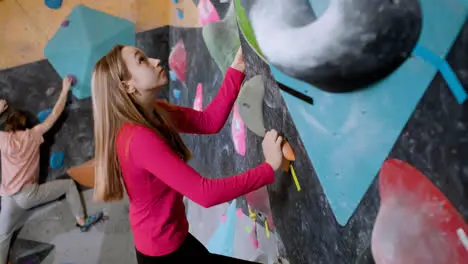 Teenagers climbing indoor