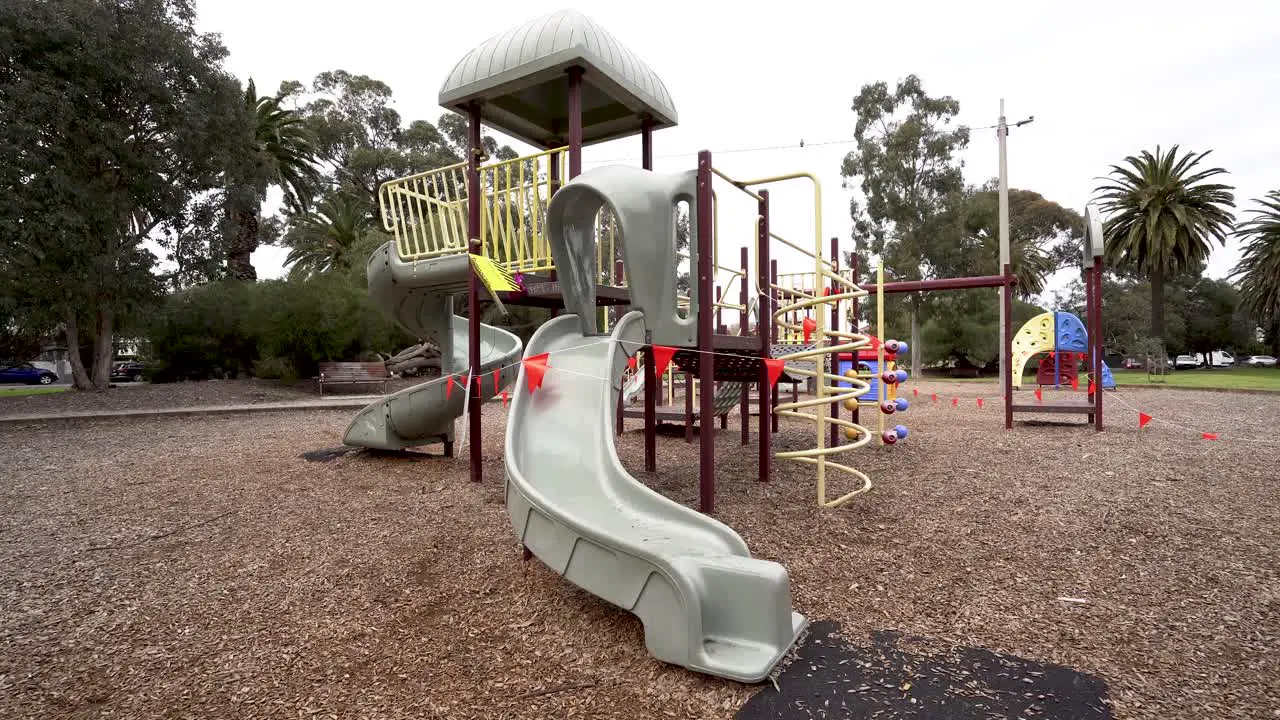 4K wide shot of roped off playground during pandemic lockdown