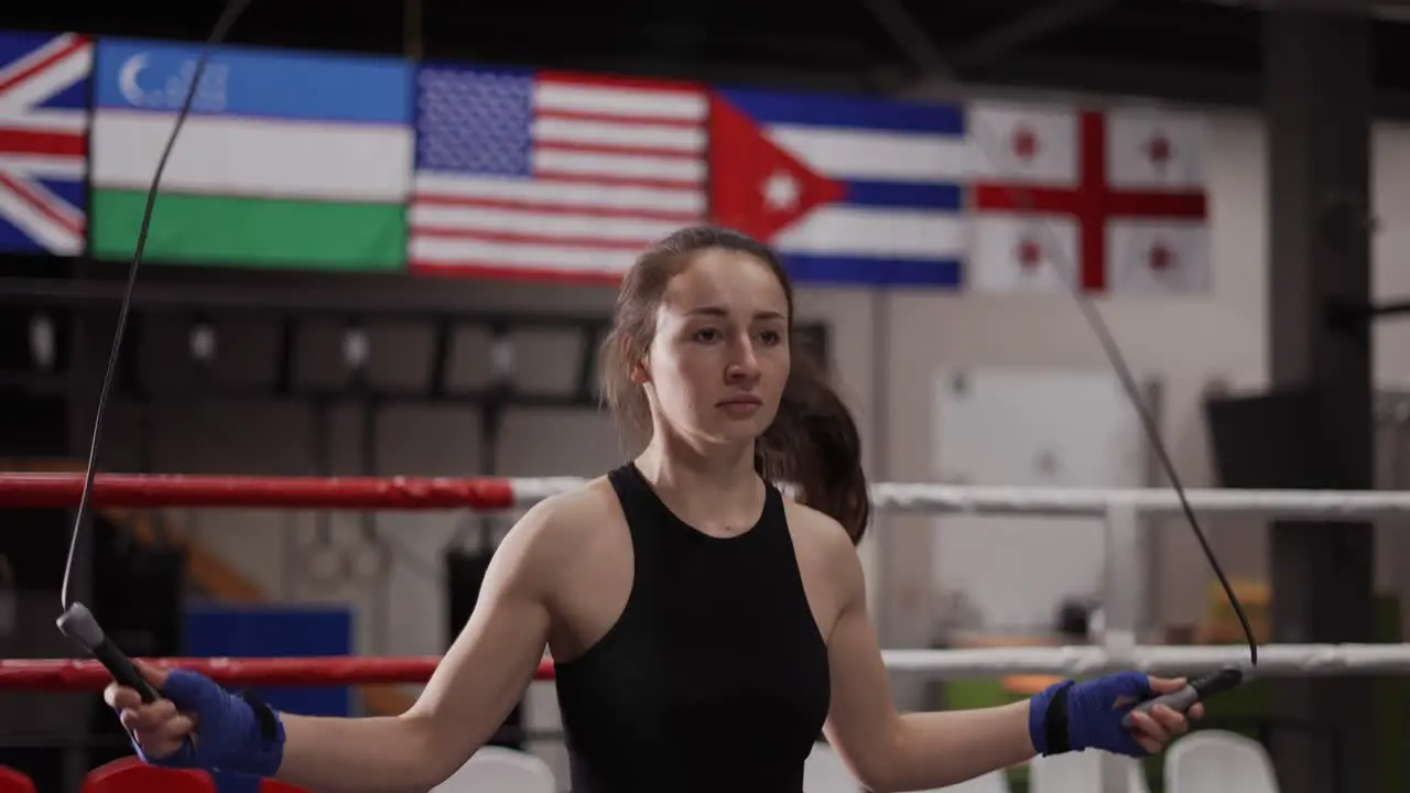 Young Female Boxer With Her Hands Wrapped In Bandage Jumping On The Skipping