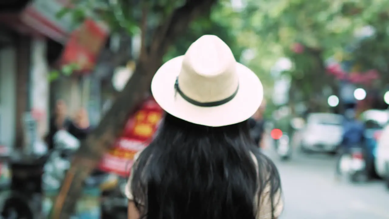 Handheld view of Vietnamese woman walking in the city