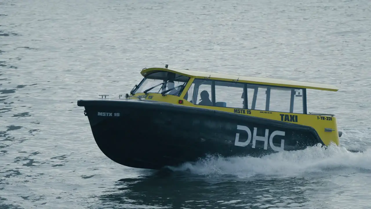 A taxi boat in the waters of the dutch city of Rotterman on a grey overcast day