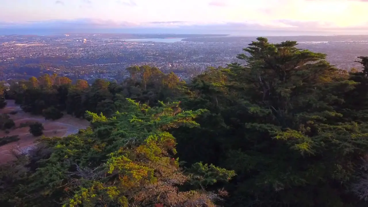 Incredible sunset with natural forest and city below in the valley Brilliant sunset colors and depth