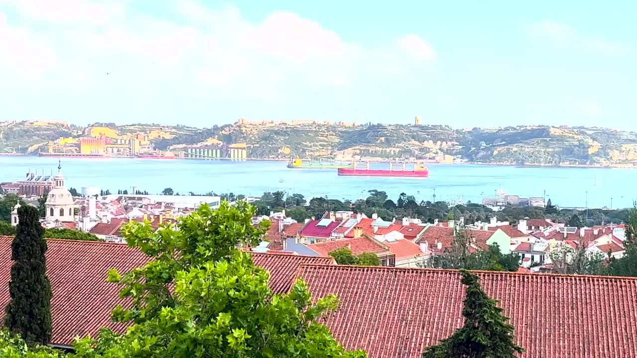 City of Almada on the Tagus River with ships passing by view of Lisbon