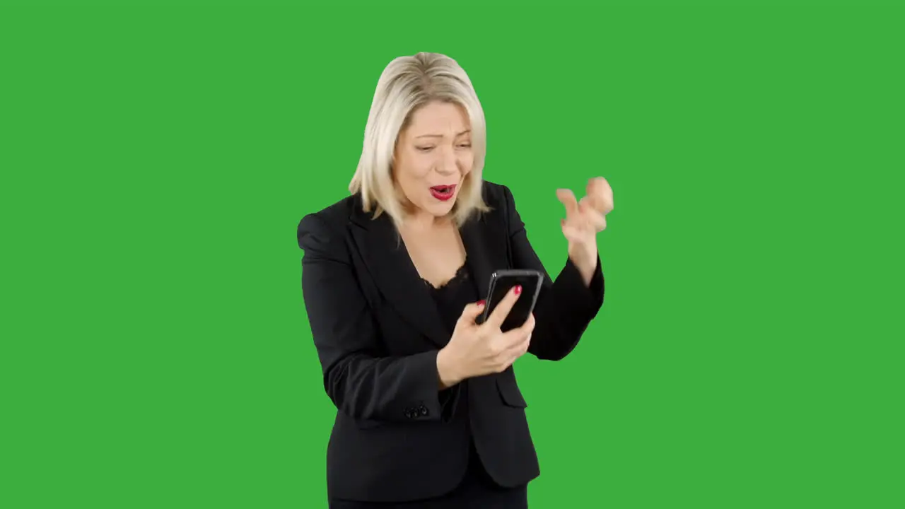 Attractive blonde business woman angry and updet as she loses money on a game app on her phone with green screen background