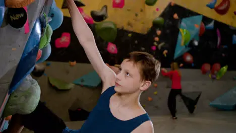 Teenager climbing indoors