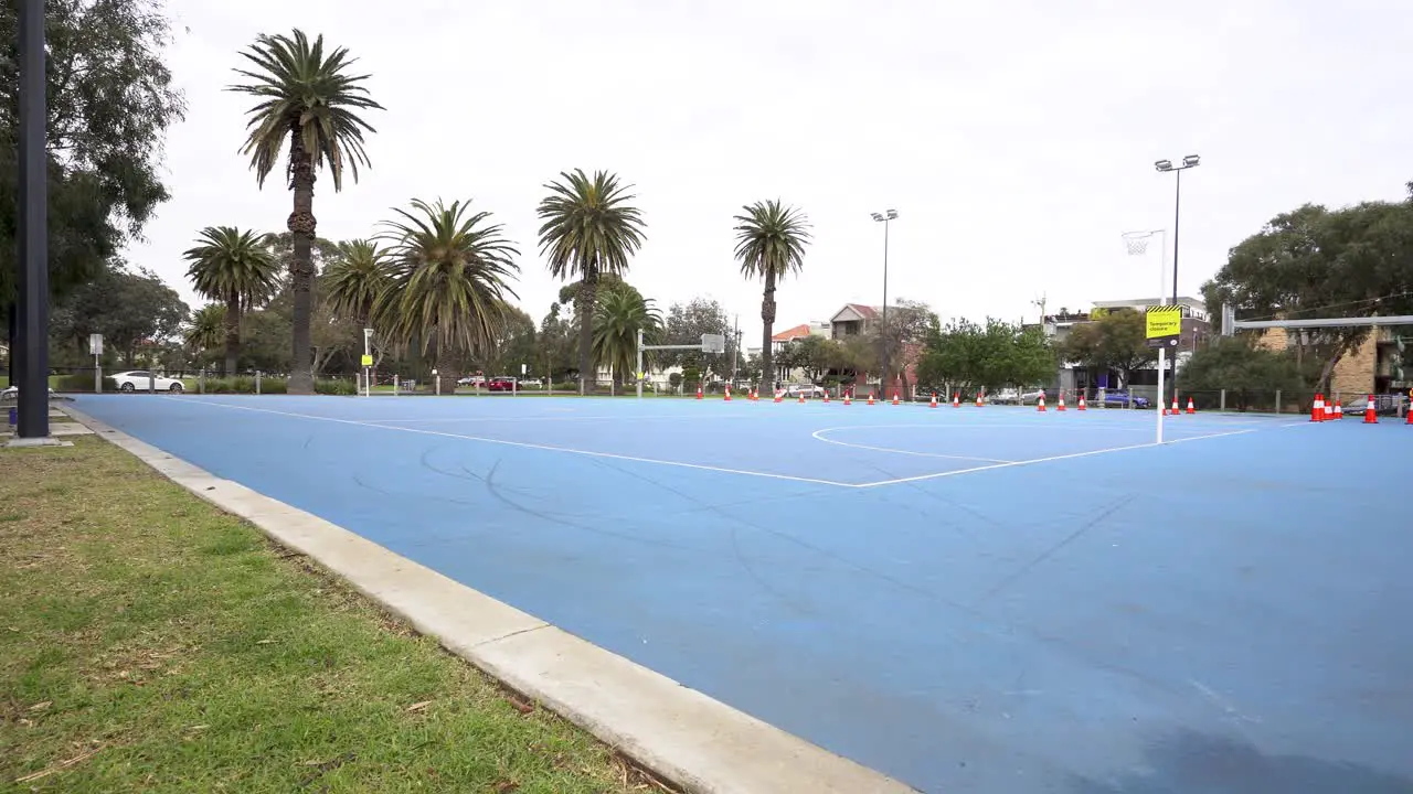 4K wide shot of empty outdoor basketball court during pandemic lockdown