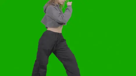 Close Up Studio Shot Of Young Woman Having Fun Dancing Against Green Screen